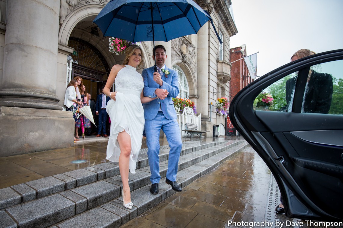 Bride and groom under umbrella