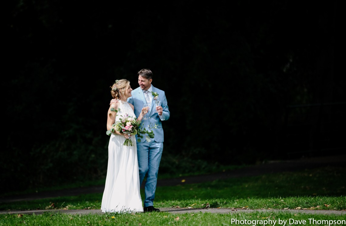 Bride and groom against a black background
