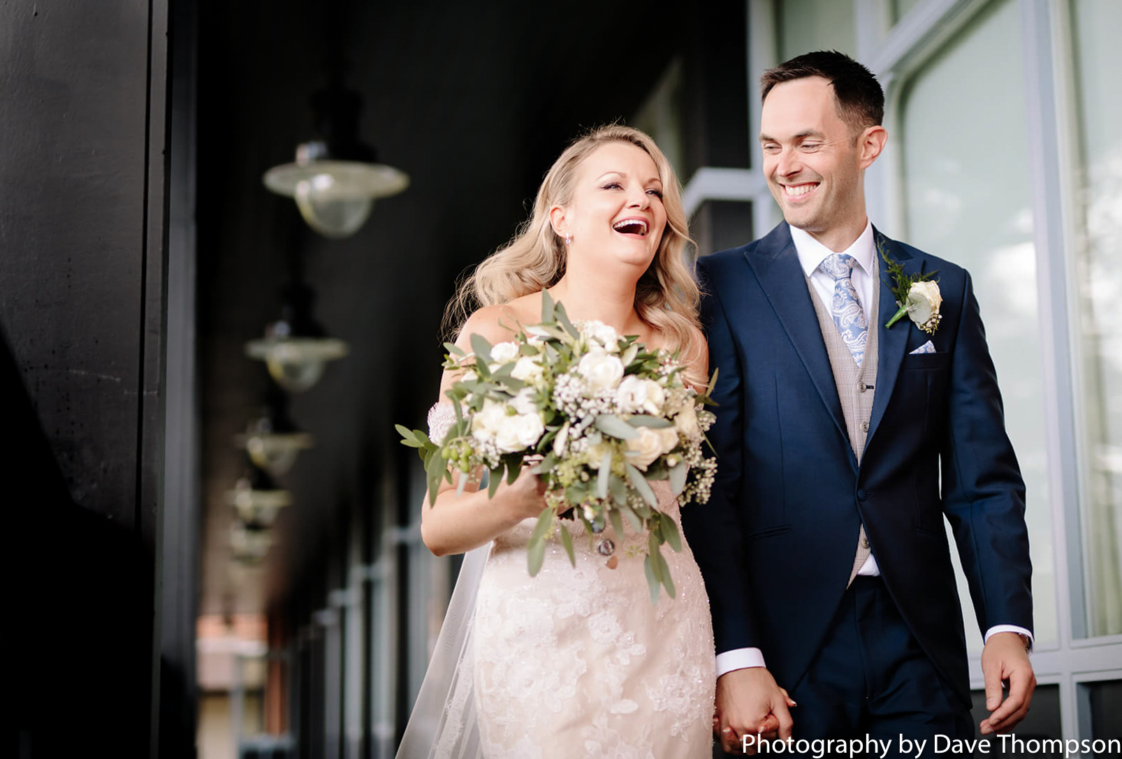 The bride and groom laugh after their wedding 