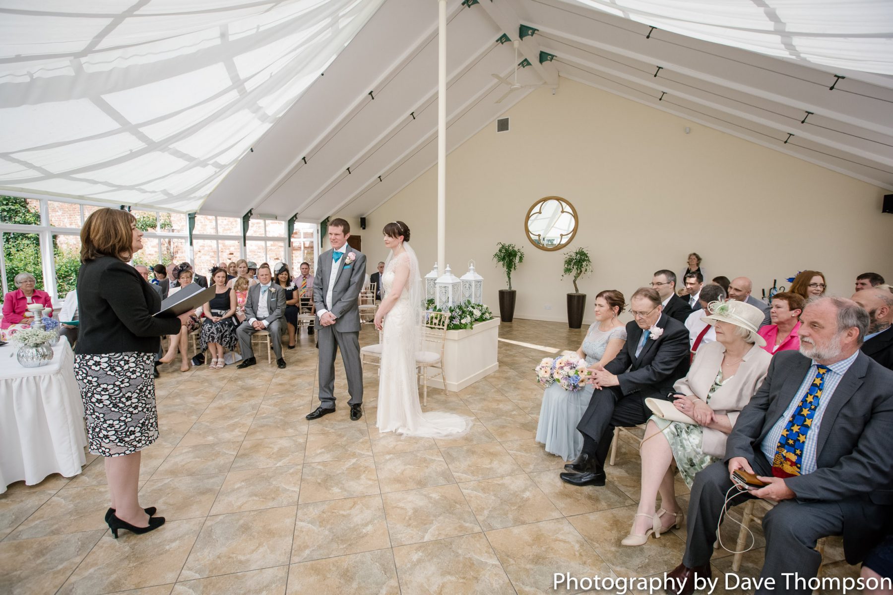 A wedding ceremony in The Edwardian Glass House at Combermere Abbey
