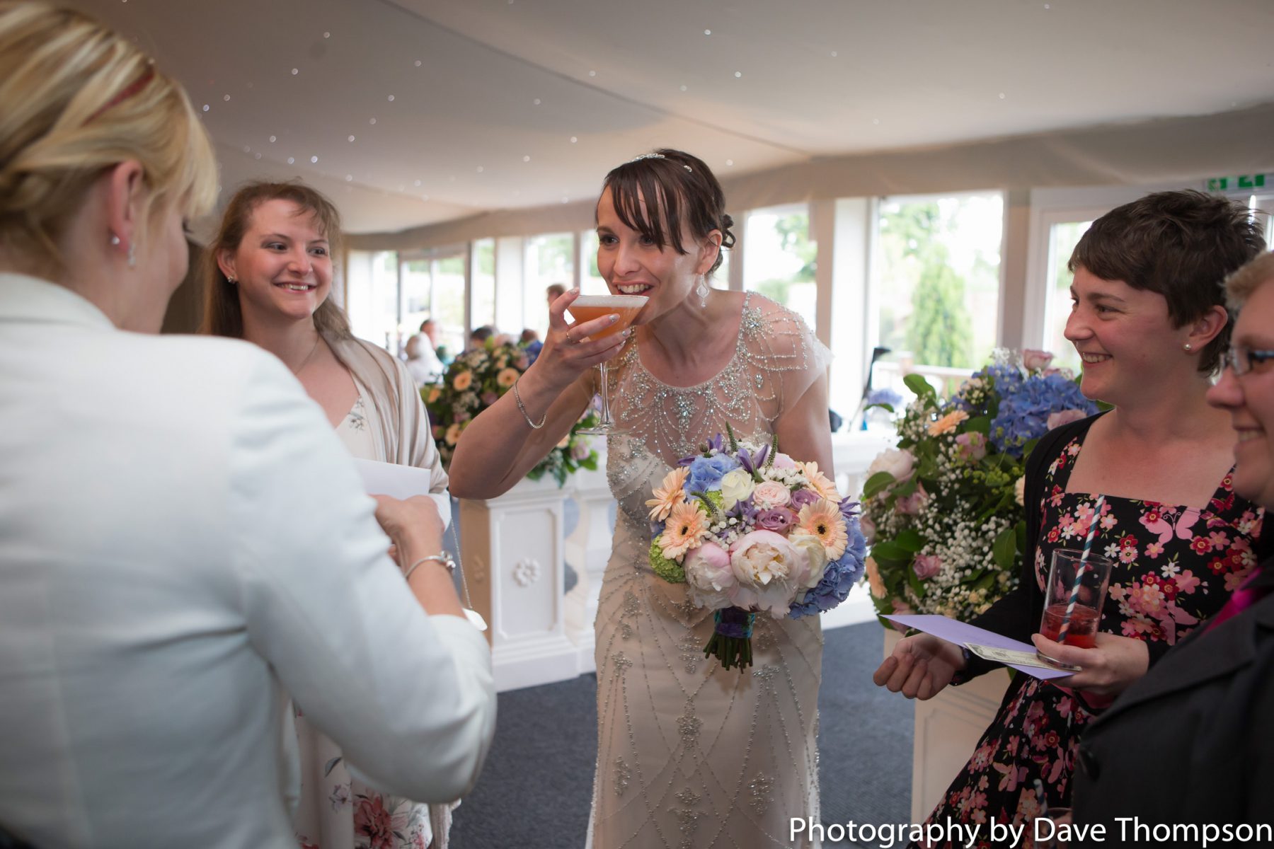 The bride drinking a cocktail