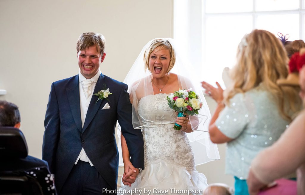 Newlywed couple walking down the aisle