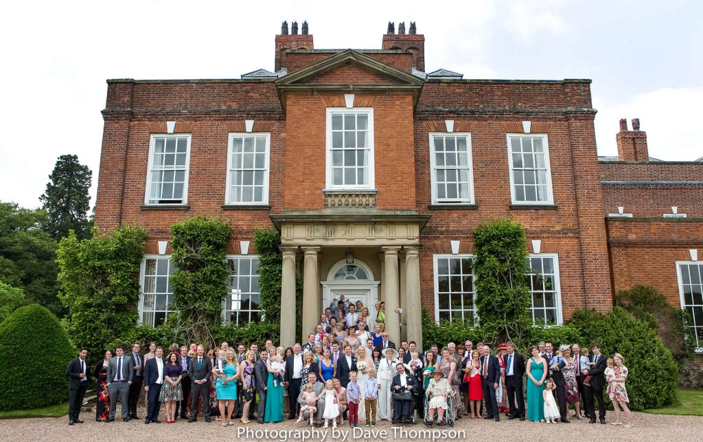 A family group photograph outside Iscoyd Park Wedding venue