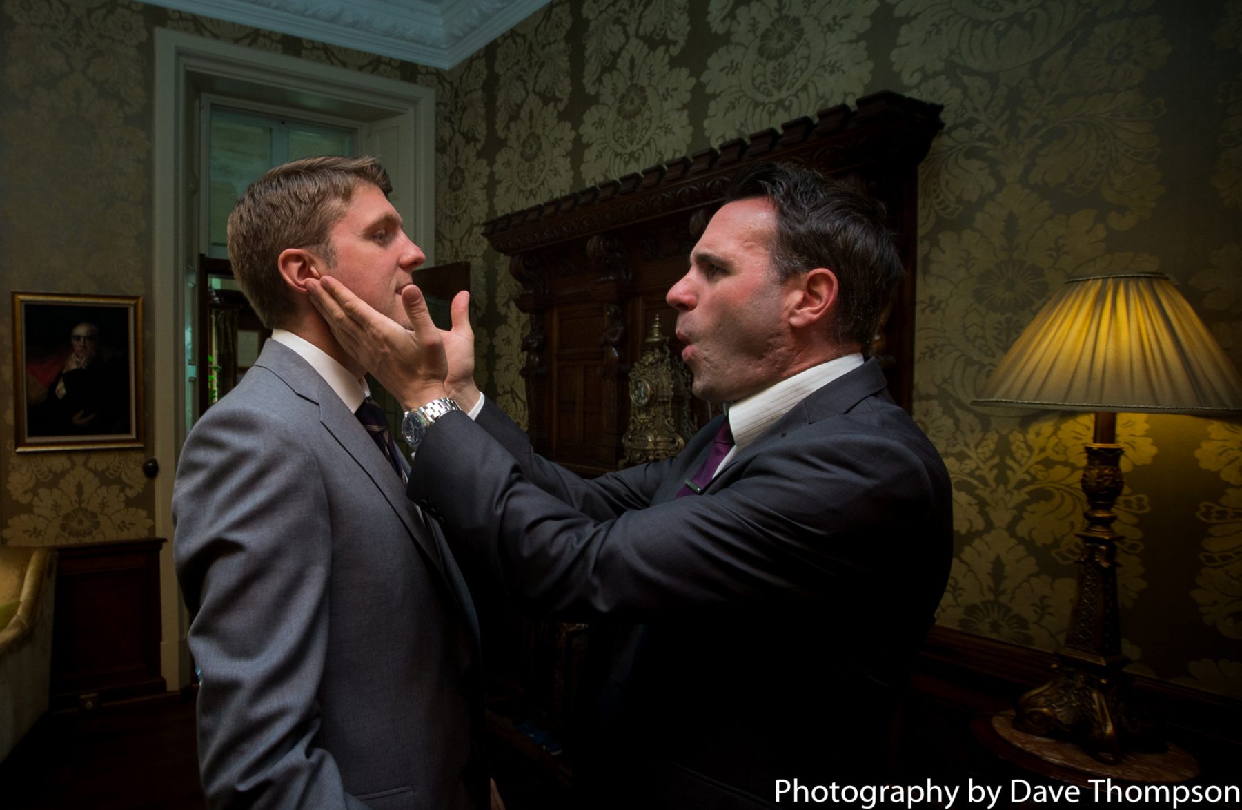 The best man slaps the cheeks of the grooms face