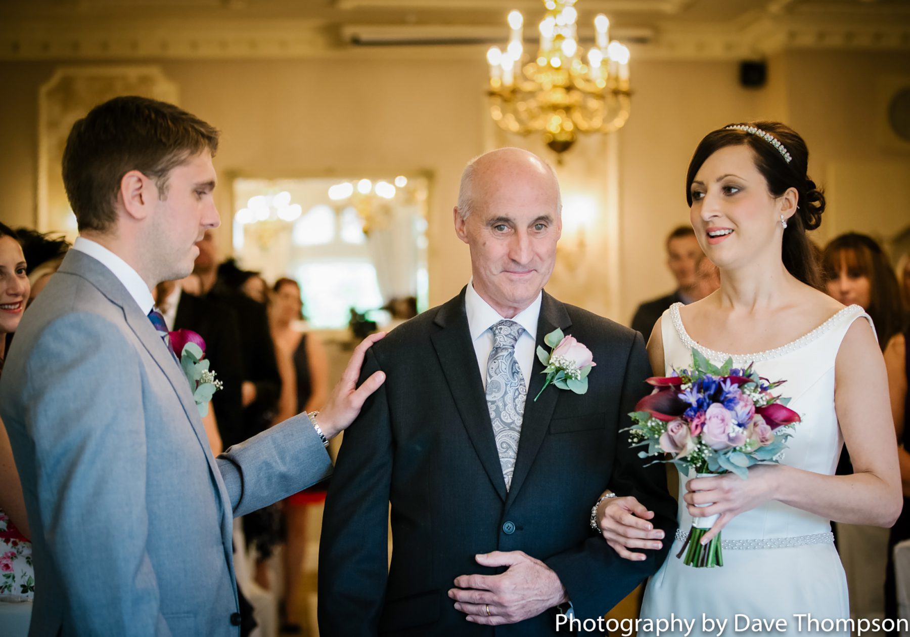 The bride and her father arrive next to the groom at the top of the aisle.