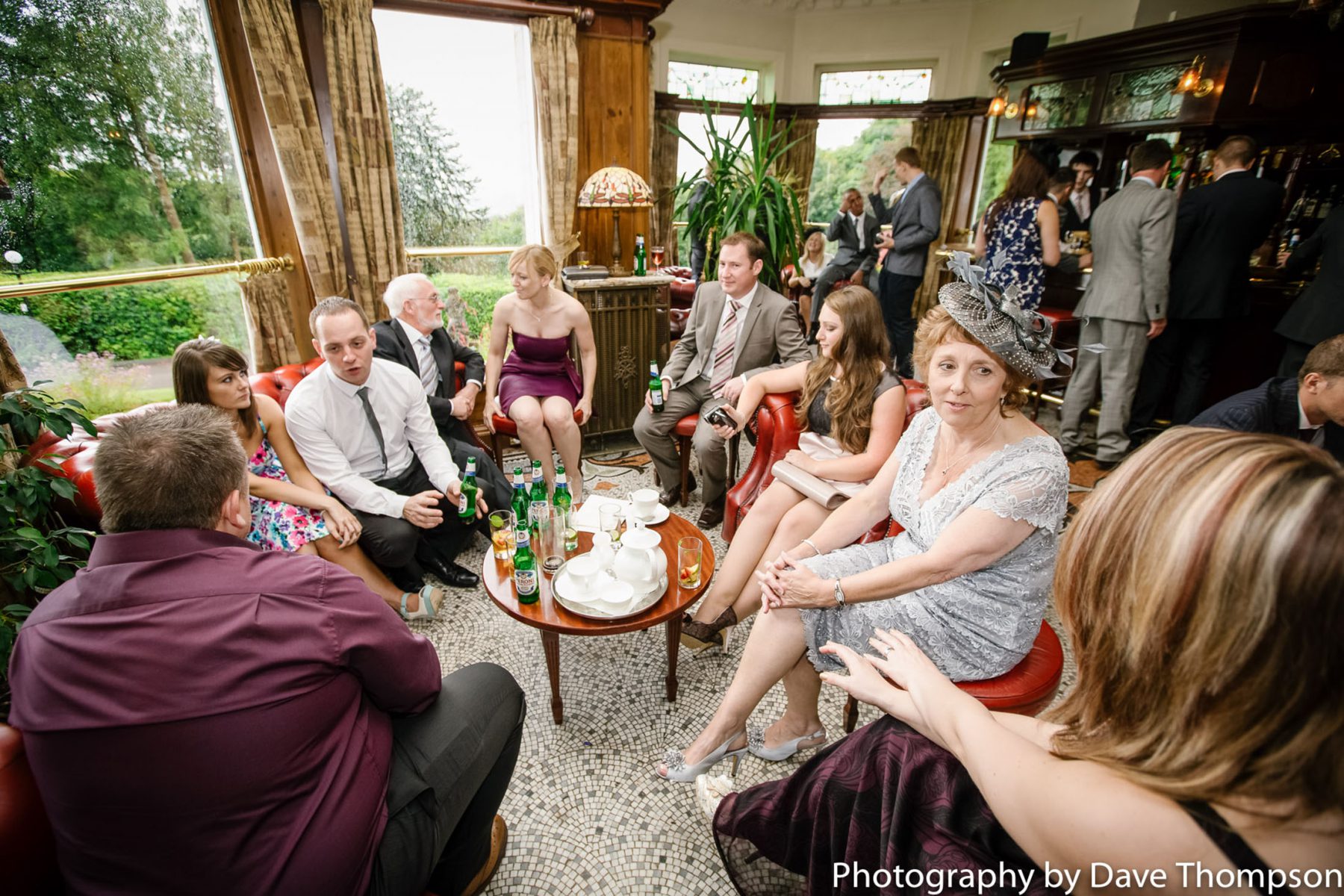Wedding guests gather in the bar