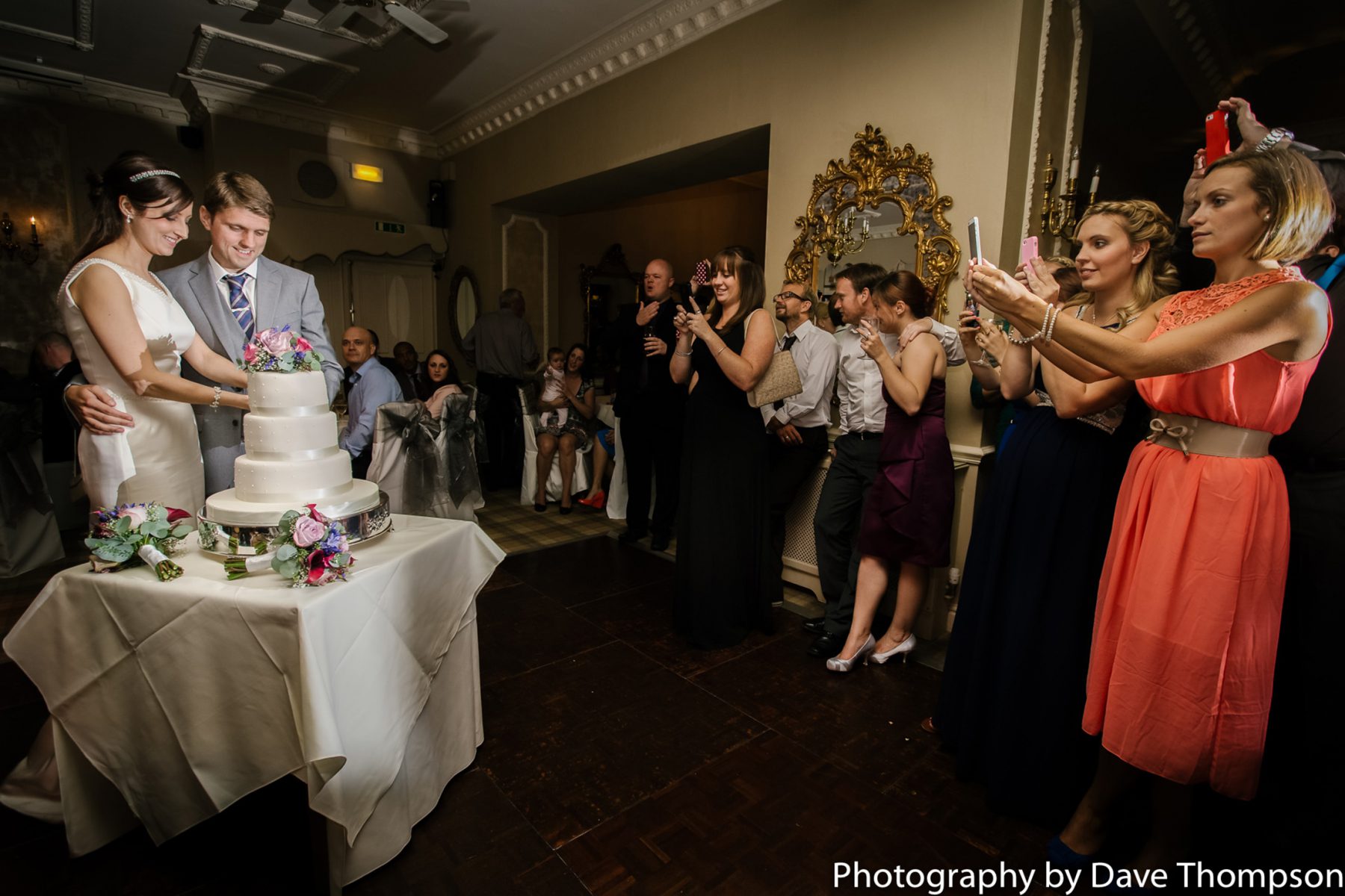 The bride and groom cut the cake