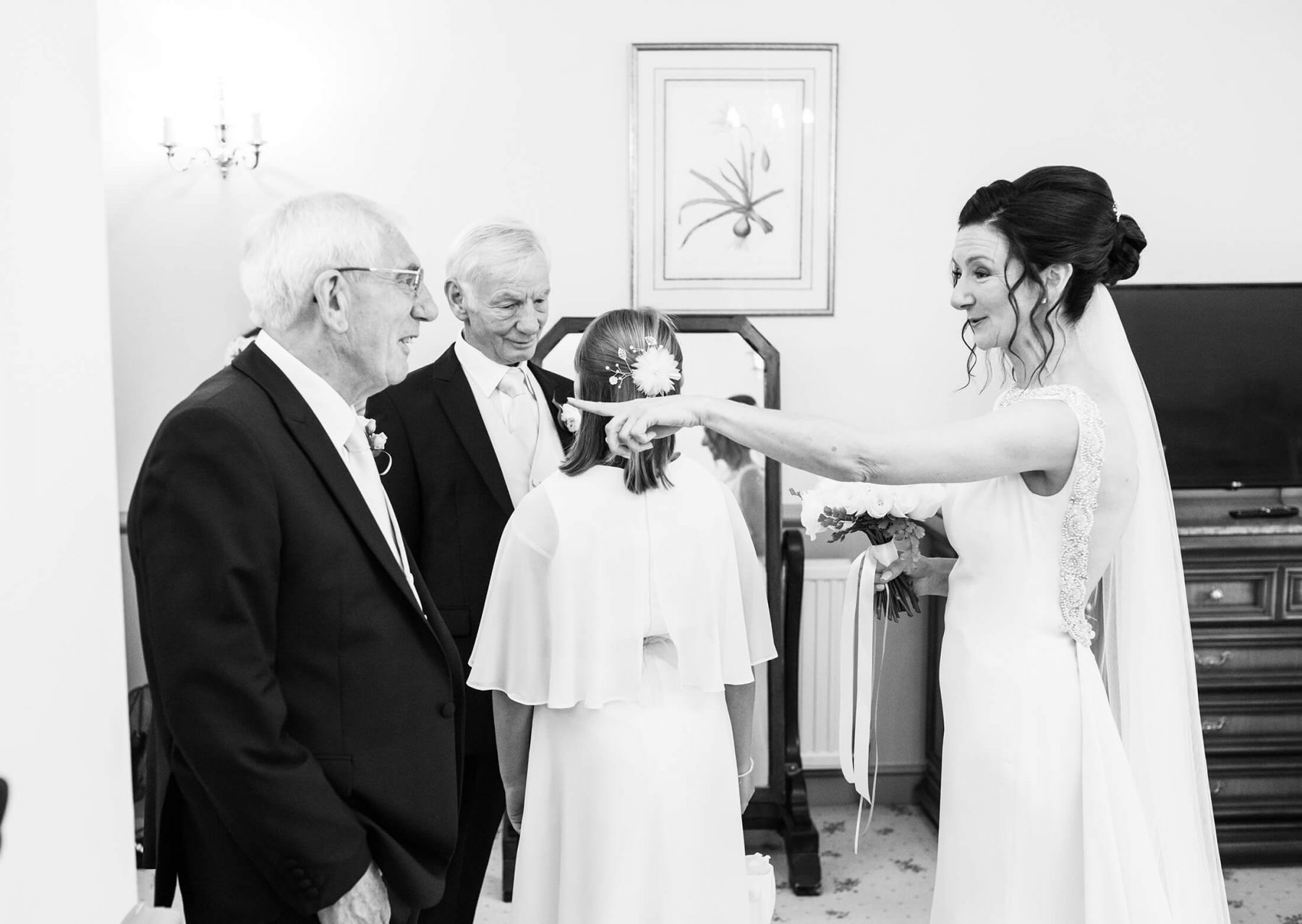The bride talks to her father and step father before the wedding ceremony