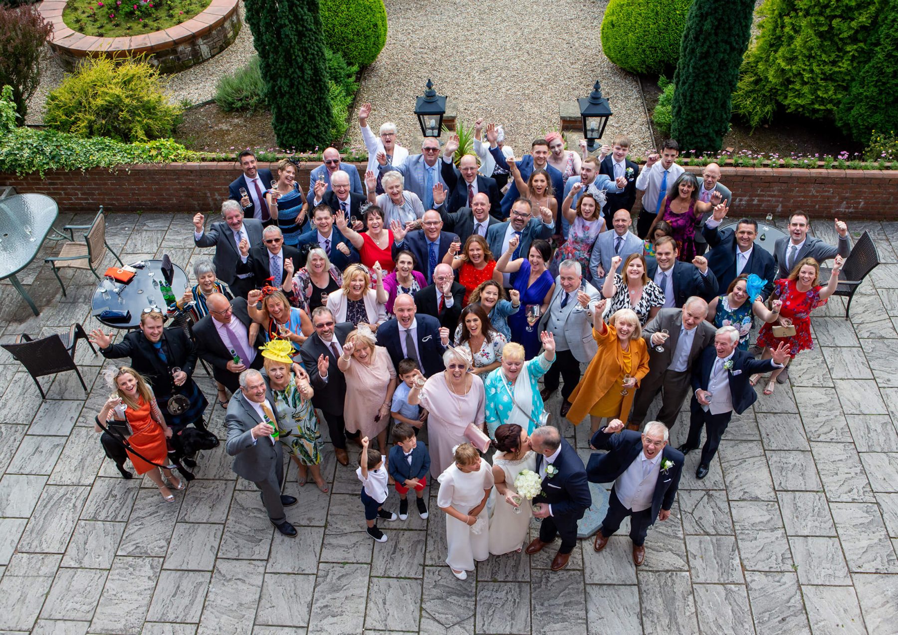 A group shot of the bride and groom and all their wedding day guests.