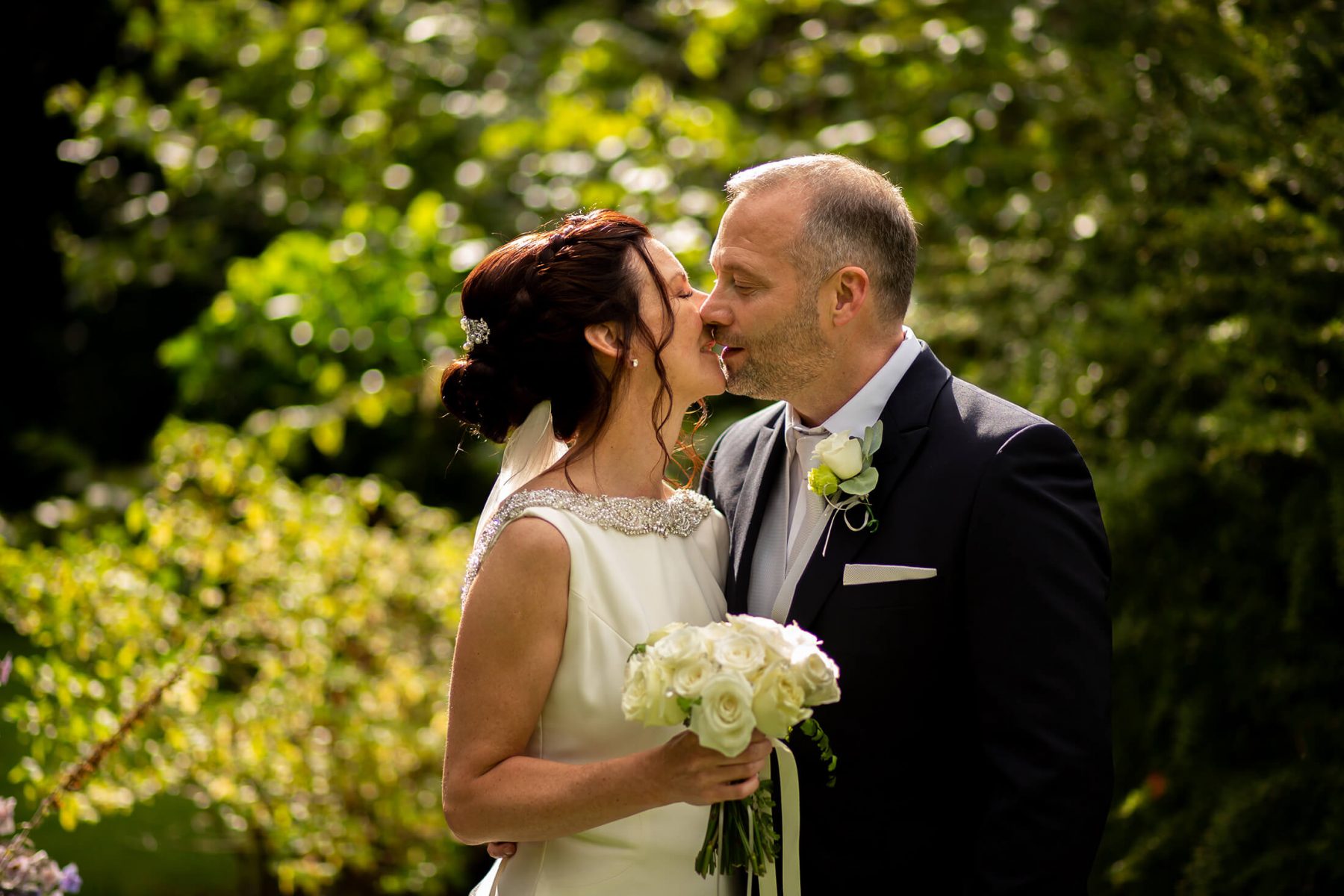 The bride and groom share a kiss after their wedding.