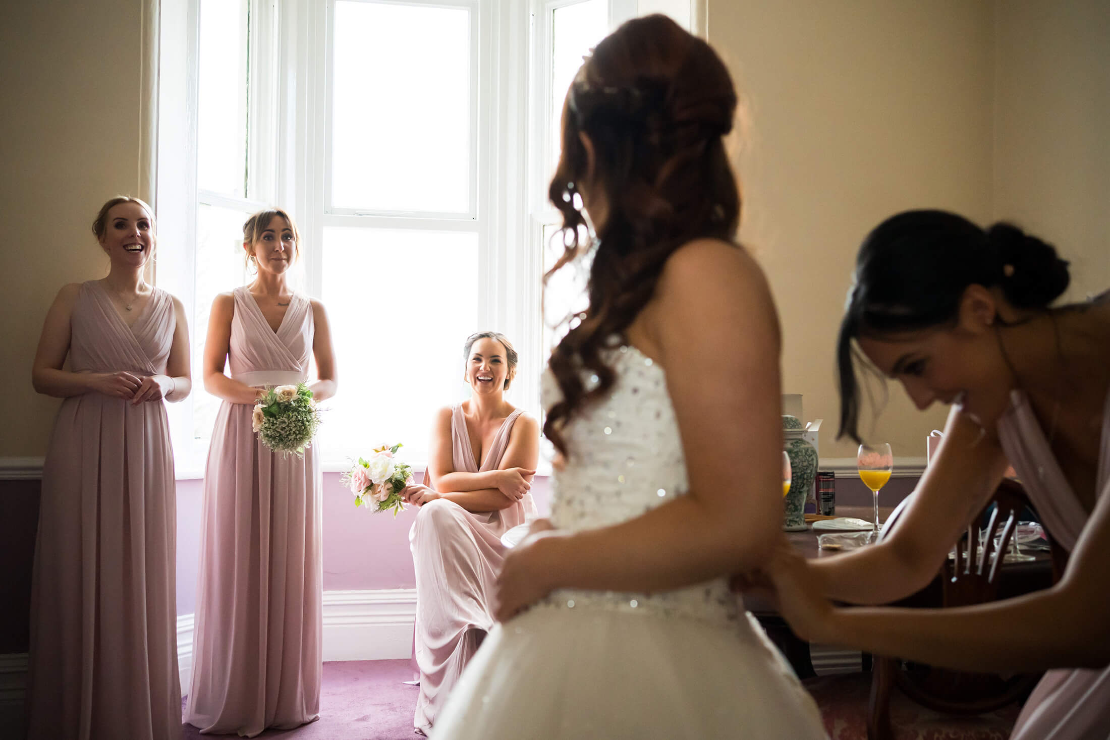 Hollin Hall Hotel Wedding Photographer - The bride laughs with her bridesmaides