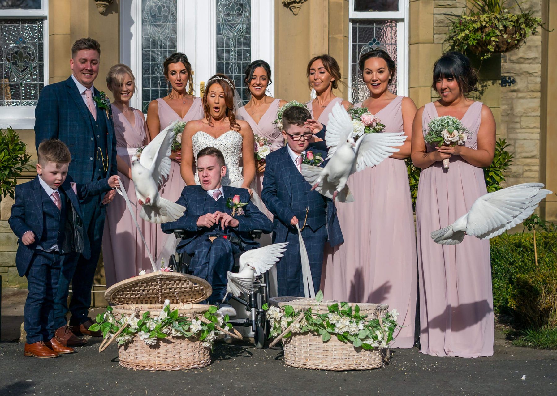 Hollin Hall Hotel Wedding Photographer - The bride and groom with family members as they release white doves into the sky