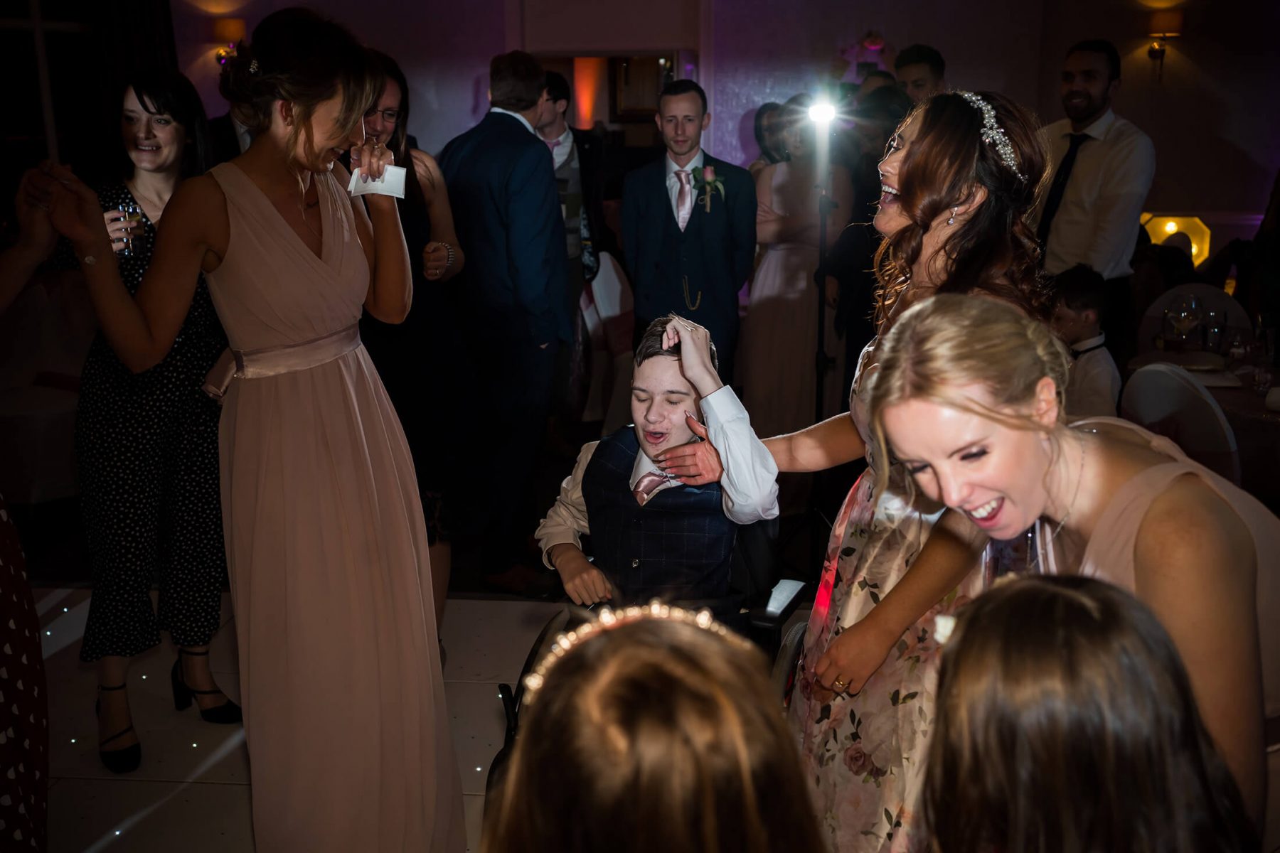 Hollin Hall Hotel Wedding Photographer - The bride's son dances in his wheelchair during the first dance
