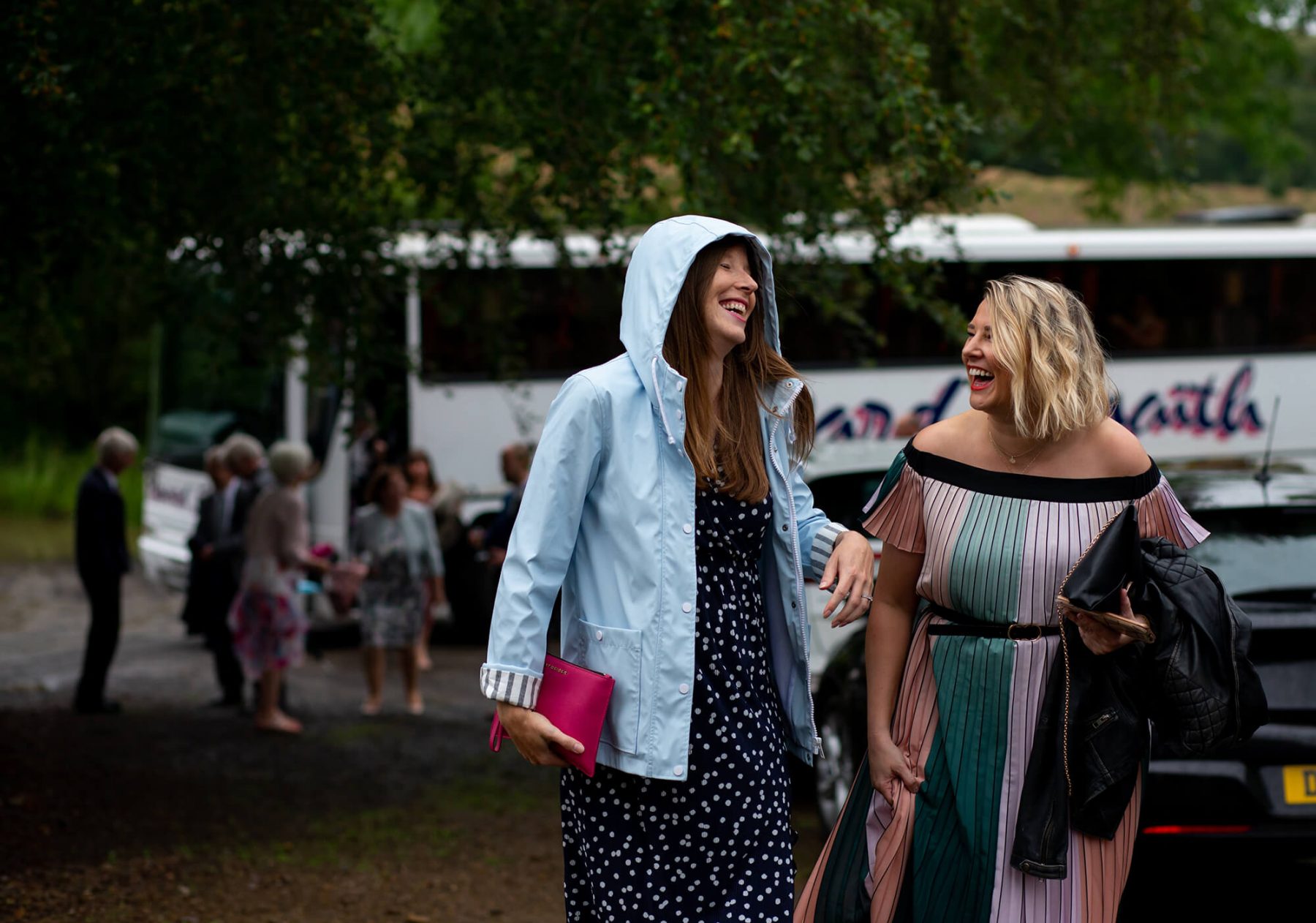 Wedding guests arrive in the rain