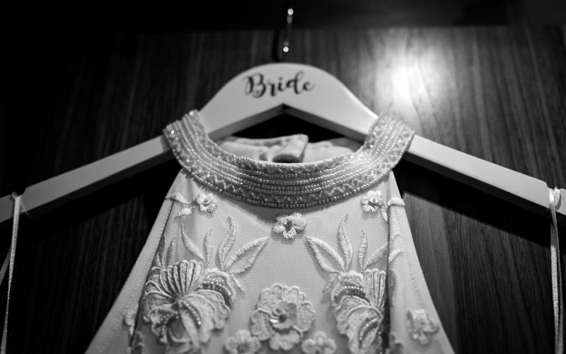 A brides dress hands from a wardrobe door