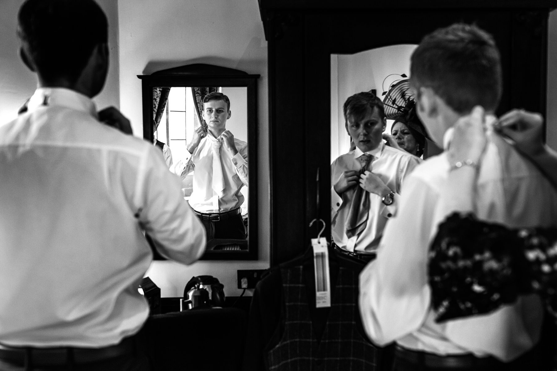 A groom gets ready prior to he wedding at Peckforton Castle