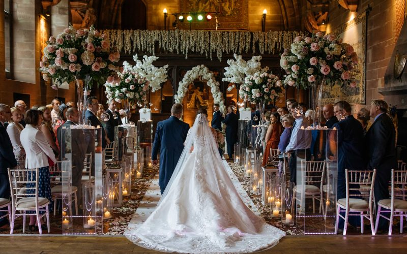 A father walks his daughter down the aisle at Peckforton Castle