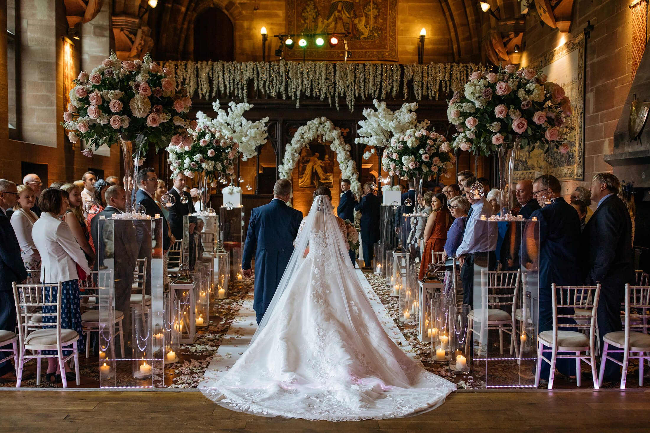 A father walks his daughter down the aisle at Peckforton Castle