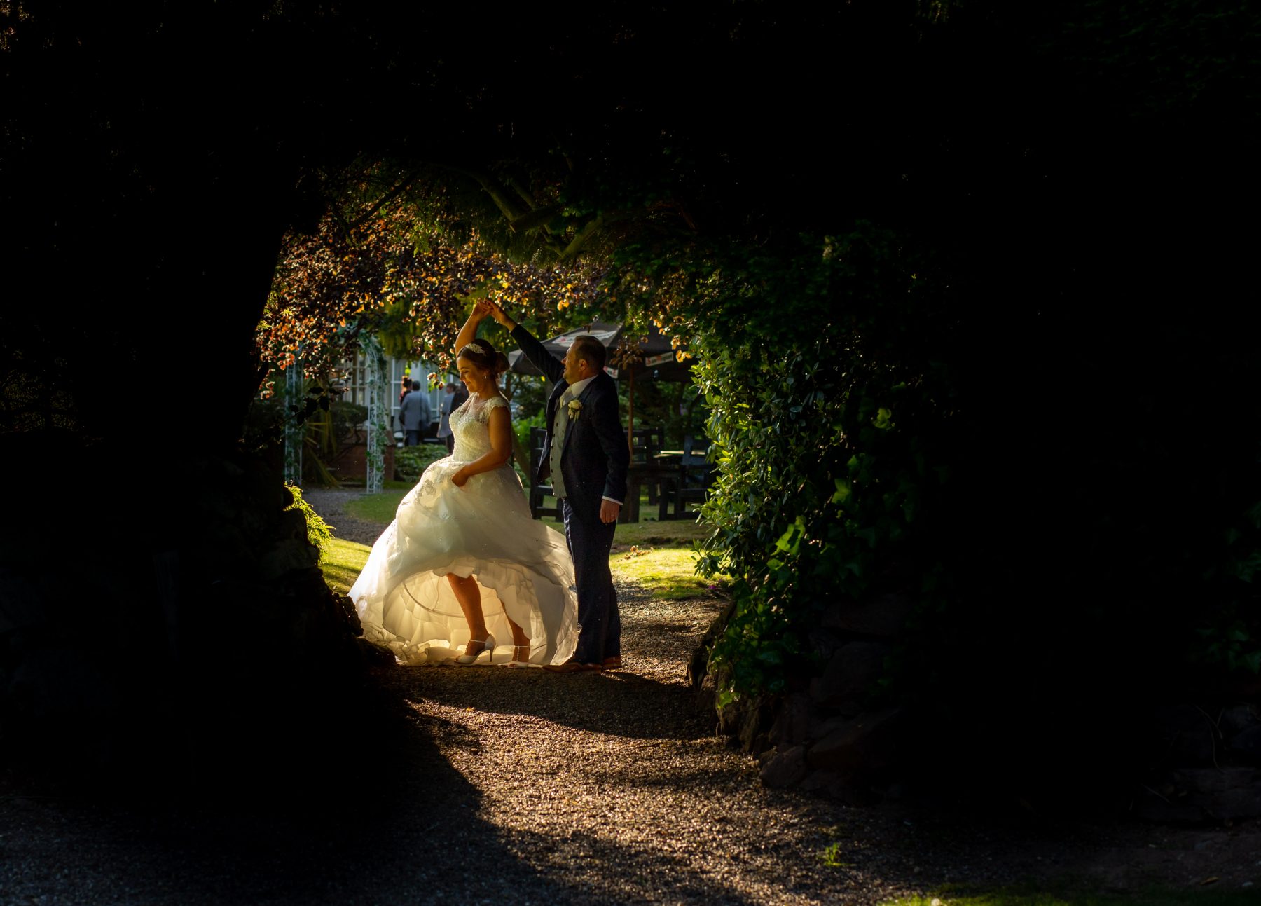 A bride and groom dance in the gardens at Mere Court Hotel