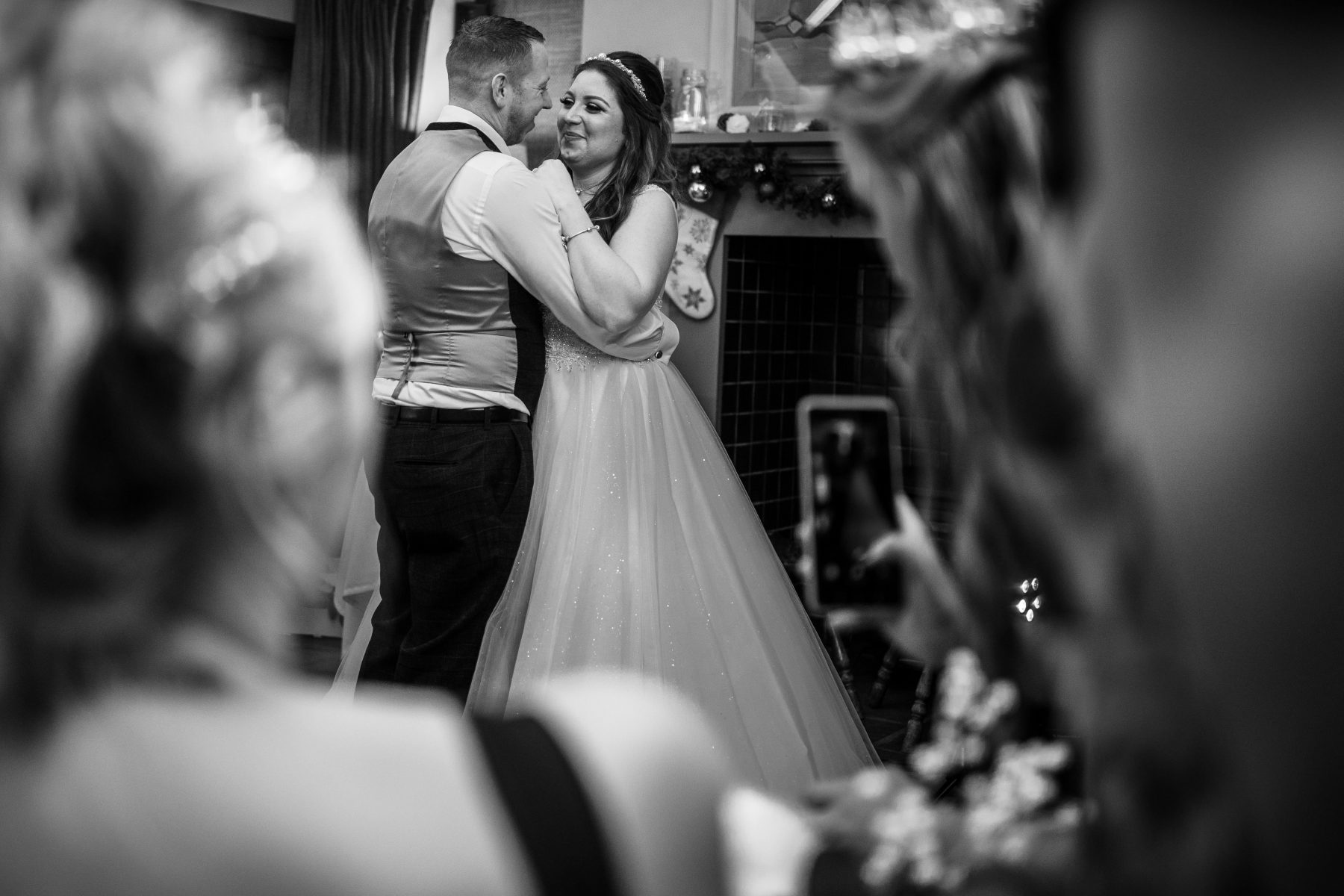 The bride and groom during thier first dance, in black and white